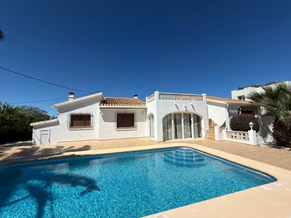 White Mediterranean villa beside a swimming pool